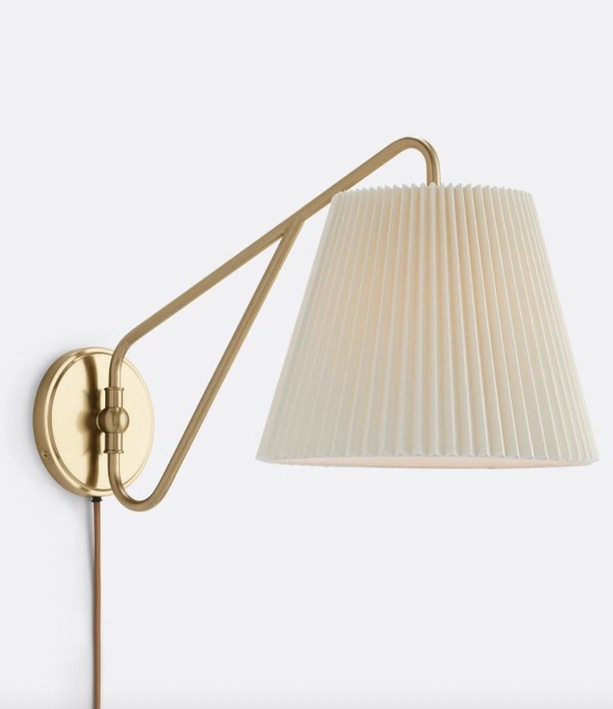 Brass wall sconce for layered lighting in a Ralph Lauren style room
