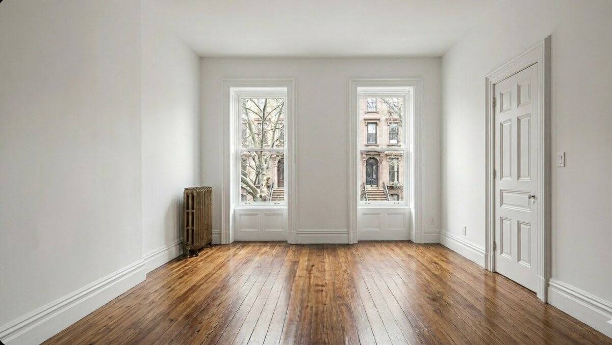 Empty white box apartment with bare walls and wood floors before decorating
